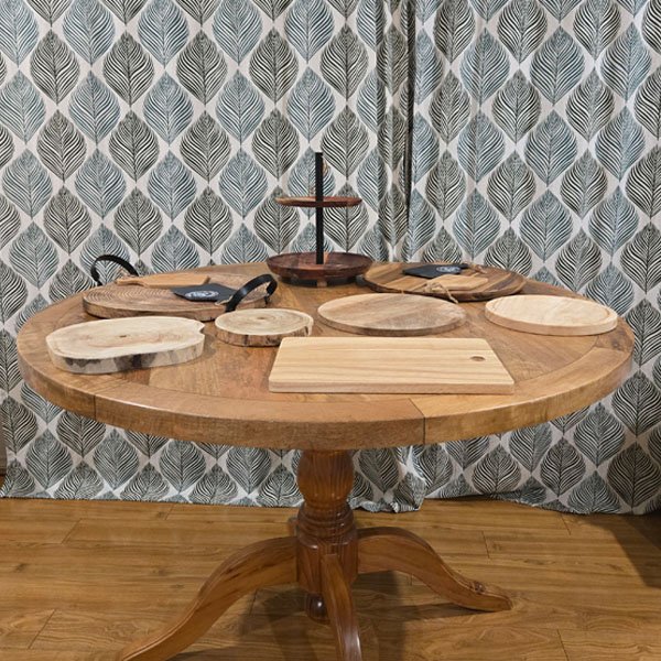 A collection of rustic wooden grazing boards and serving platters from LuvDeco, including live-edge wood slices and a two-tiered stand, available for wedding and event hire.