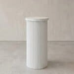 Elegant white fluted pedestal for modern decor or display.