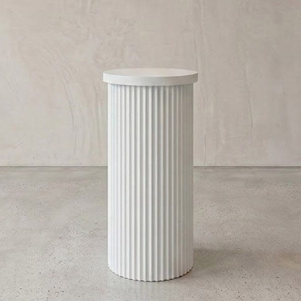 Elegant white fluted pedestal for modern decor or display.